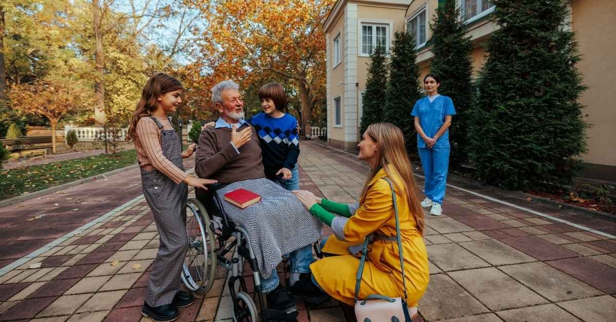 Elderly people enjoying social interaction with a nurse providing home health care support in New Jersey, showing comfort and happiness at home.